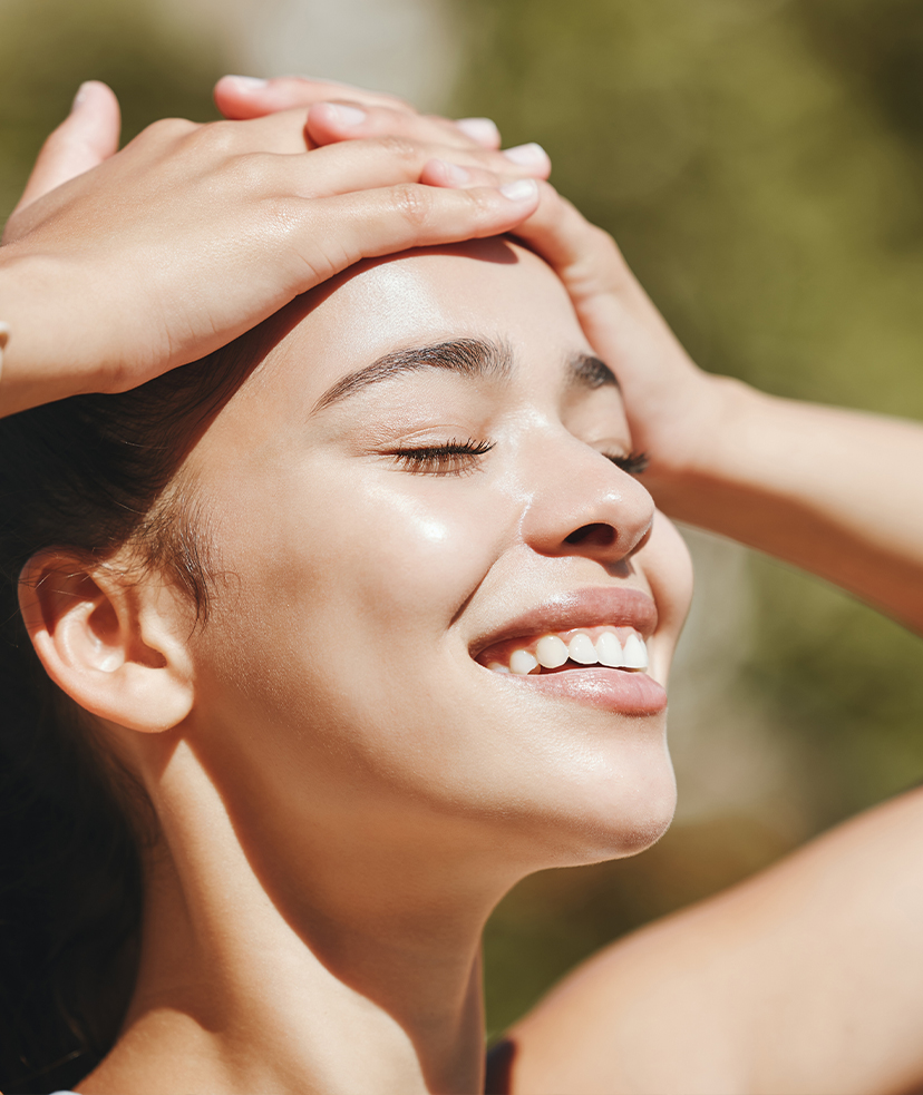 Photo of a smiling woman in the sunshine