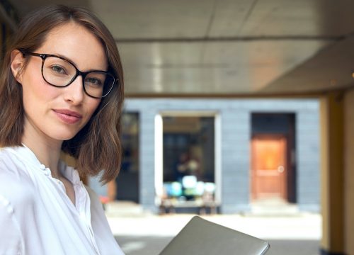 Photo of a woman wearing glasses and a white blouse